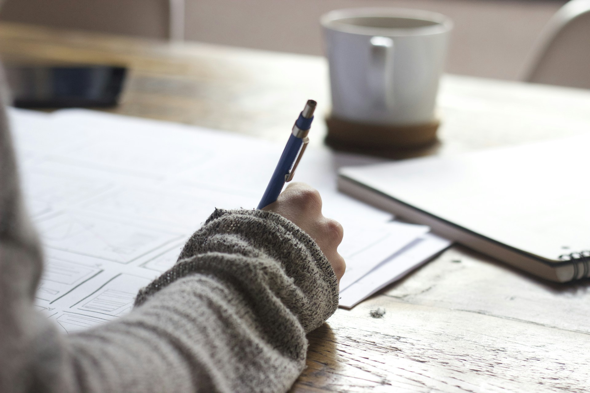 Facilitator at a desk preparing narrative training materials before a corporate session